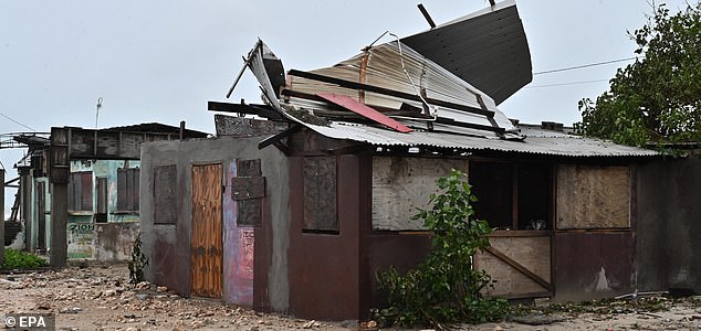 epa12486750 A house stands damaged by the preliminary winds of Hurricane Melissa at Hellshire Fishing Beach in Portmore, Jamaica, 27 October 2025. Jamaican Prime Minister Andrew Holness said the government has a multifaceted plan to ensure a 'swift and effective' response to the storm's imminent impact on Monday night and forecast to be the island's strongest recorded storm.  EPA/RUDOLPH BROWN