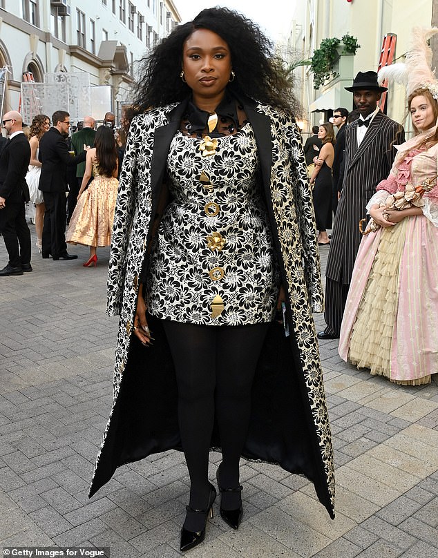 Jennifer Hudson wore a clashing cape-like coat with a bold black and white floral pattern and large gold buttons