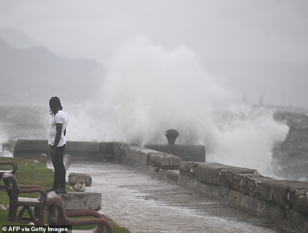 The storm has not yet made landfall in Jamaica, but has already been blamed for three storm-related deaths on the island. Pictured: Waves crash in the waterfront in Kingston, Jamaica