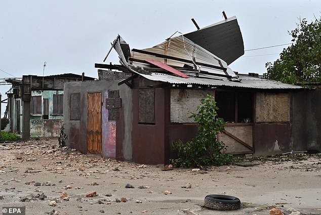 The wind speeds will be strong enough to destroy houses by tearing off roofs. Before the storm's arrival, some houses have already been severely damaged (pictured)