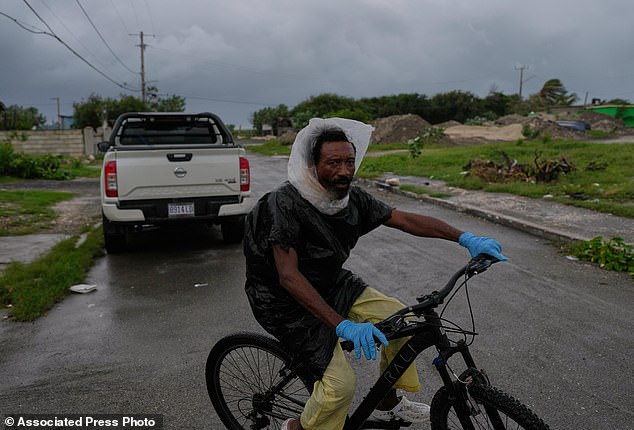 Although Jamaica is considered well-prepared for hurricanes compared to some islands in the Caribbean, experts are concerned that Melissa may be too strong to properly prepare for. Pictured:  A man rides a bike ahead of the arrival of Hurricane Melissa