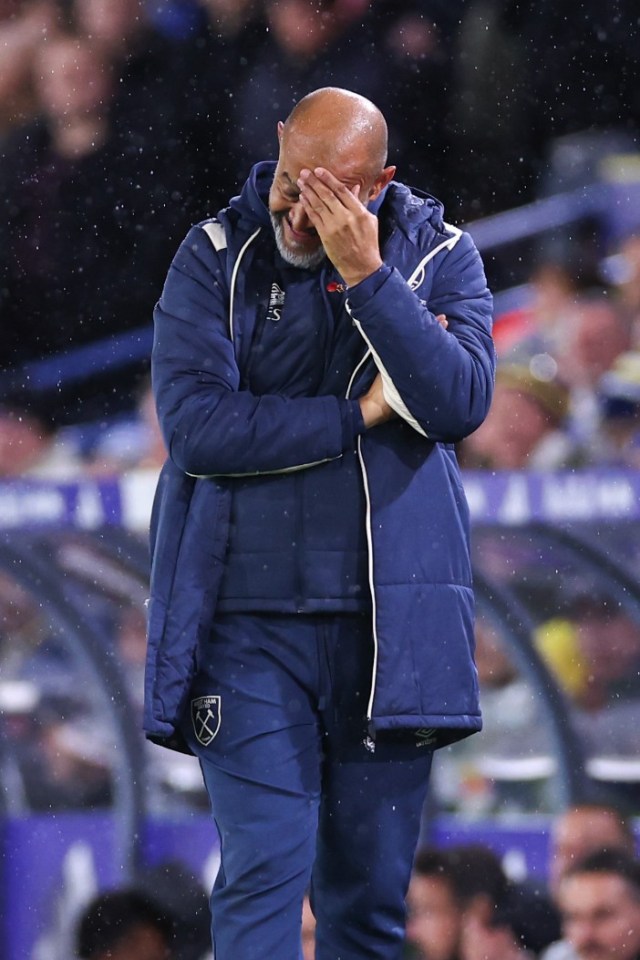 West Ham manager David Moyes holds his head in disappointment during a match.