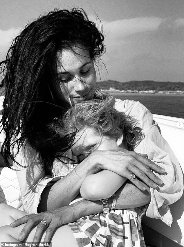 The Duchess of Sussex previously shared a black and white photo of herself cuddling Princess Lilibet, who was sat on her lap, with the pair both sporting windswept hair