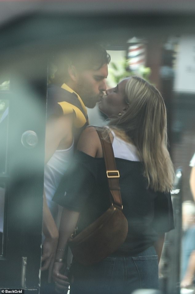 The two showcased their love by enjoying a sweet smooch while picking out the best orange winter squash ahead of Halloween