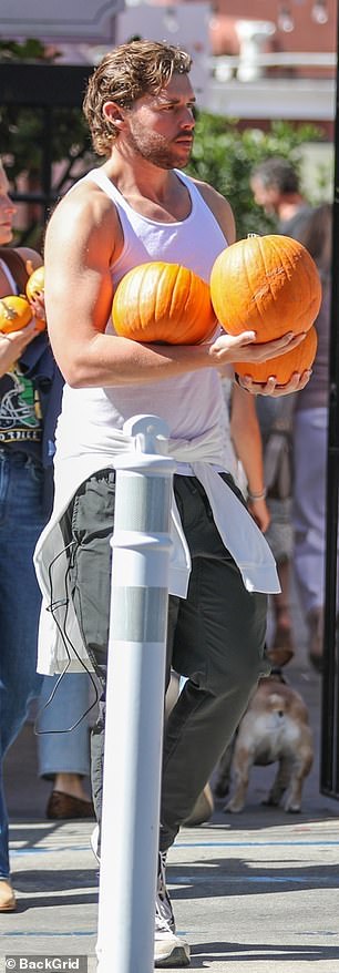 He also donned a pair of grey trousers as he had a white sweater tied around his waist