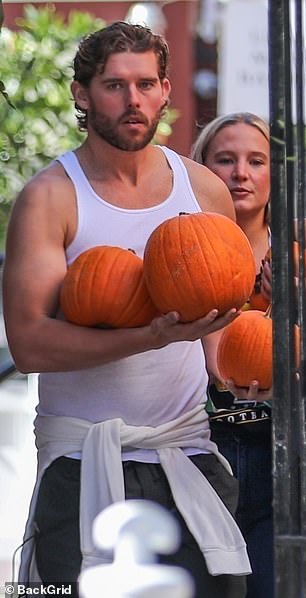 Juggling multiple pumpkins did not seem like such a major task with his muscular arms