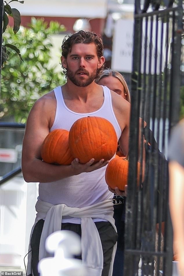 His medium-length brown locks were combed back as he sported a bit of scruff on his face