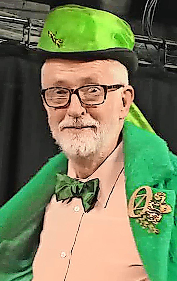 Man wearing a green hat, green jacket, and green bow tie.