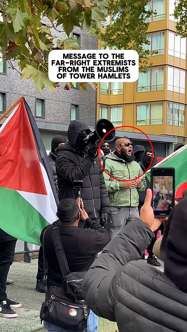 'Big fish' is seen on stage as a masked protester delivers a speech with a megaphone