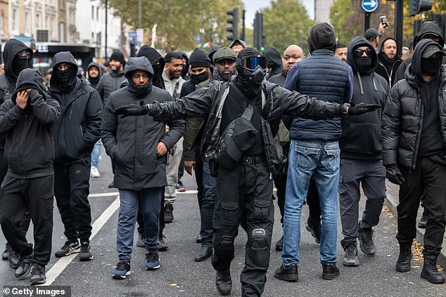Masked men took to the streets of east London vowed to 'defend their community' against far-right protesters