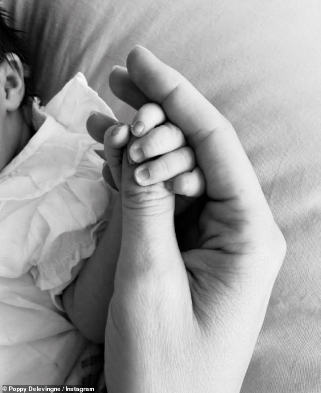 Poppy Delevingne has welcomed her first child with her partner Archie Keswick. The socialite announced the news on Friday with a black and white snap clutching her baby girl's hand