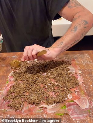 The former photographer lay out spinach on cling film before layering prosciutto and the mushroom on top and wrapping the beef in it
