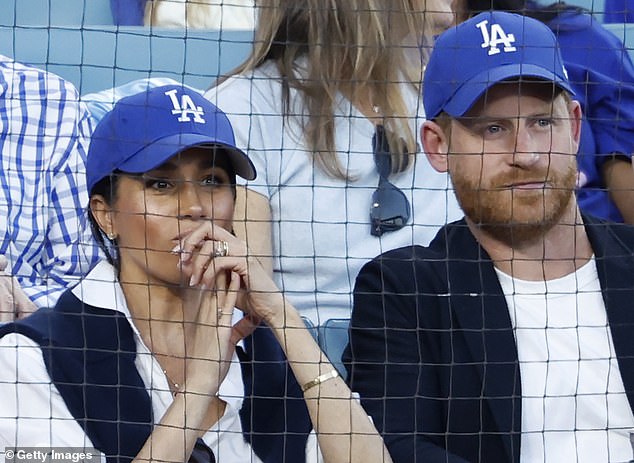 The Duke and Duchess of Sussex looked laidback at Dodger Stadium, Los Angeles , in matching black-and-white outfits, with Meghan, 44, casual in a loose-fitting white shirt, black gilet, and blue LA Dodgers caps