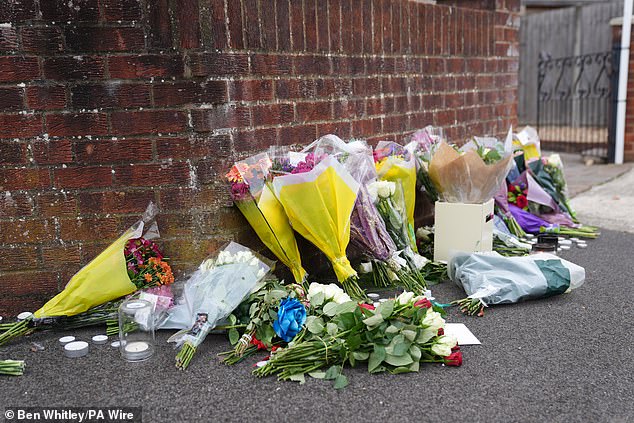 Pictured: Flowers left near the scene after the attack. An Afghan refugee has been charged with the murder of a dog walker stabbed to death in Uxbridge