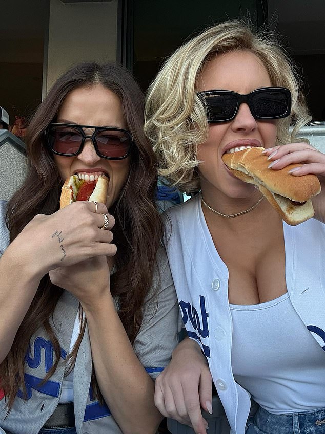 The star struck a suggestive pose as she bit into the fast food treat while flashing her cleavage