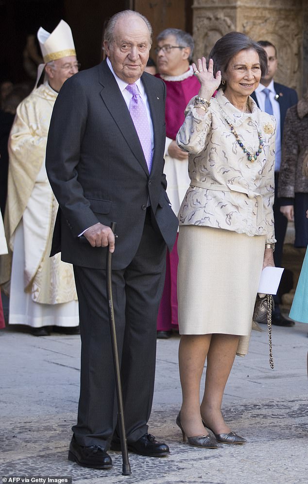 Former King Juan Carlos I of Spain (L) and his wife former Queen Sofia leave after attending the traditional Easter Sunday Mass of Resurrection in Palma de Mallorca on April 1, 2018