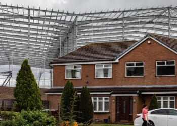 Our homes are dwarfed by 'monster' 60ft grey walls just metres away that feel 'surreal'