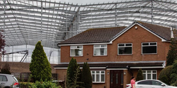 Our homes are dwarfed by 'monster' 60ft grey walls just metres away that feel 'surreal'