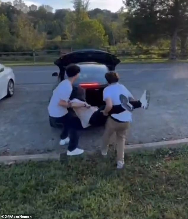 In the video, a second teen jumped into the frame, seizing the student¿s legs while another grabbed his arms and shoved him into a car trunk before it quickly drove off (pictured)