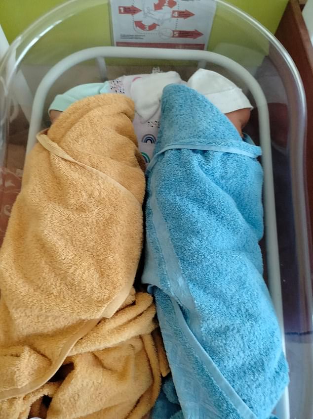Natalia Oshmarina gave birth to twins (pictured) during an air raid in southeastern Ukraine. She said: 'children of war, even at birth in patriotic towels'
