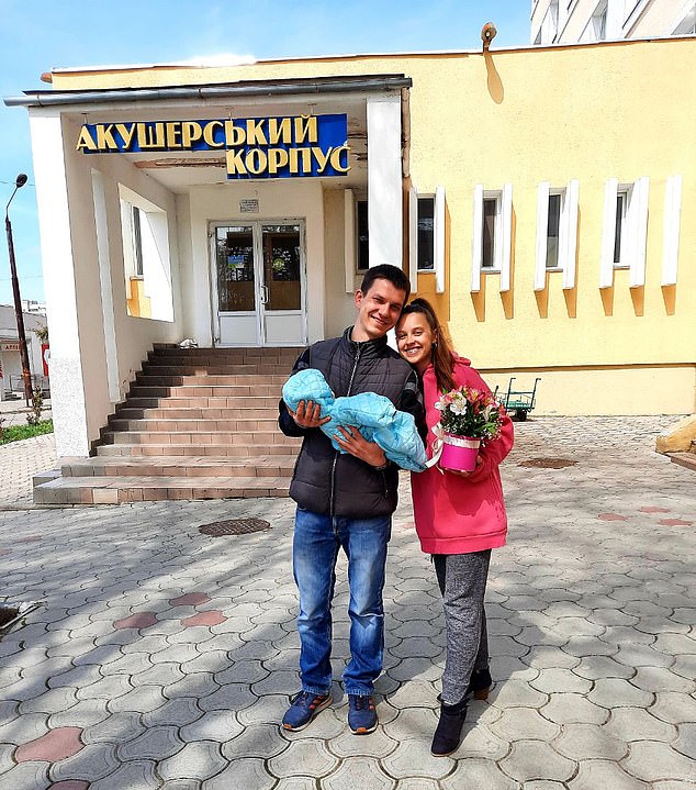 Anastasiia with her husband and their newborn baby outside a maternity hospital in Ukraine