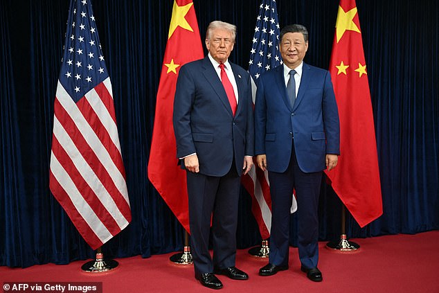 President Donald Trump (pictured left) and China's President Xi Jinping pose for photos as they arrive for talks at the Gimhae Air Base, located next to the Gimhae International Airport in Busan