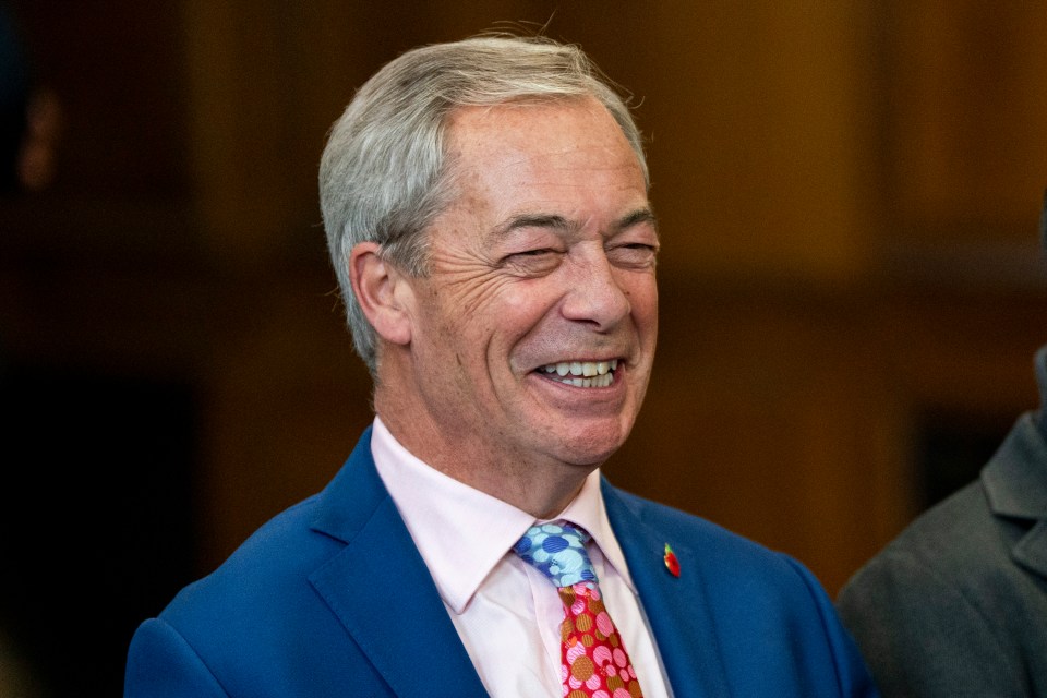 Nigel Farage laughing at a Reform UK press conference.
