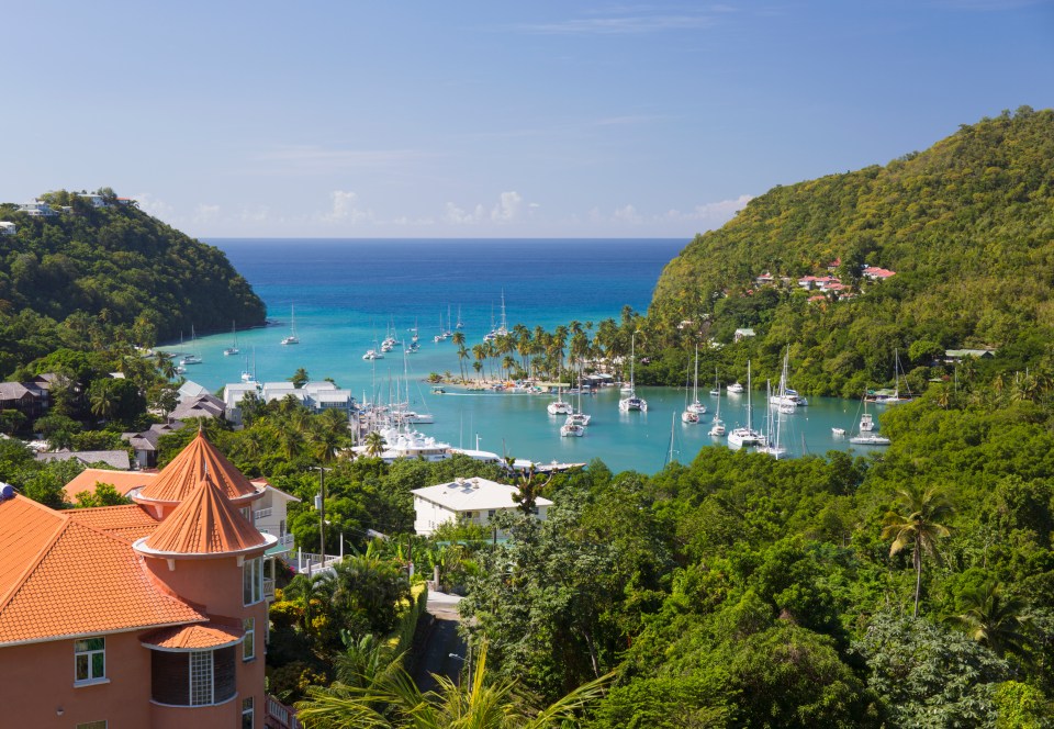 View over the sheltered harbour from verdant hillside above the village, Marigot Bay, St Lucia