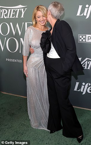 Curtis was stylish wearing a black blazer as well as matching black trousers and a white top with a large black floral embellishment