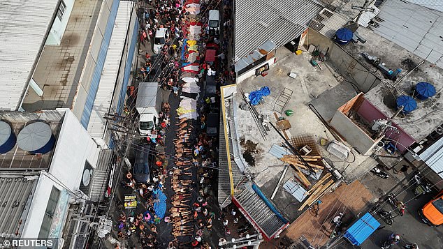 A drone views shows mourners gathering around bodies on October 29, 2025, in Brazil