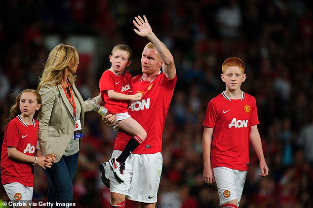 Aiden was diagnosed when he was two-and-a-half years old (pictured carried by Scholes)