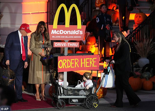 Two children greeted the president dressed in McDonalds drive-thru costumes