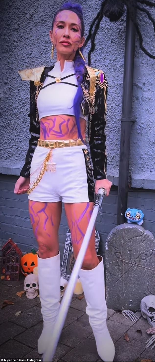 Taking to Instagram the TV personality flashed her gorgeous figure which had been adored with purple paint while her hair also featured colourful extensions