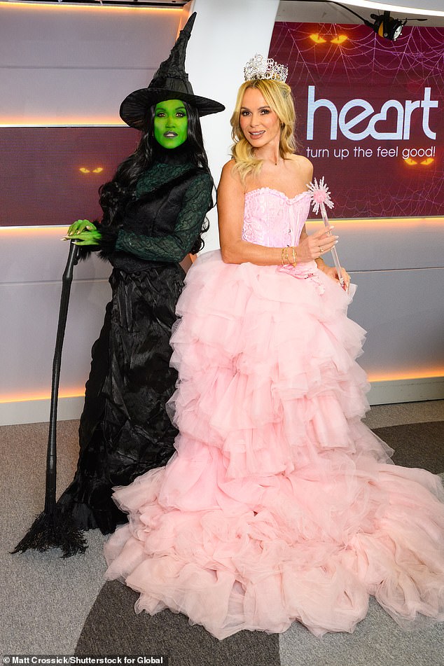 It comes after Amanda (right) channeled Glinda The Good Witch in her first outfit while her Heart FM colleague Ashley Roberts (left) dressed as Elphaba
