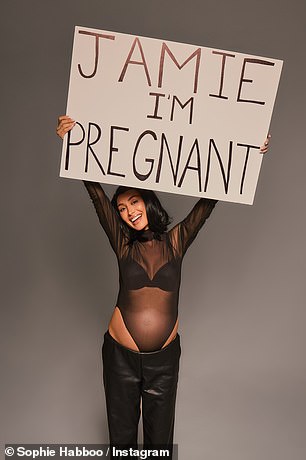 Before mimicking the moment Kourtney Kardashian held up a sign to tell husband Travis Barker she was expecting while he performed on stage