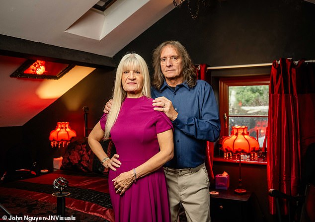 Chris and Pam in one of their home's bedrooms. They often hear footsteps and find drawers open in rooms they have not been in all day