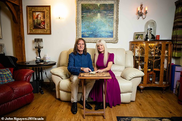 Chris and Pam with a Ouija board at their haunted home. Their interest in the paranormal has led to them working alongside a company called Haunted Happenings, which sees them accompany groups on ghost hunts around the country