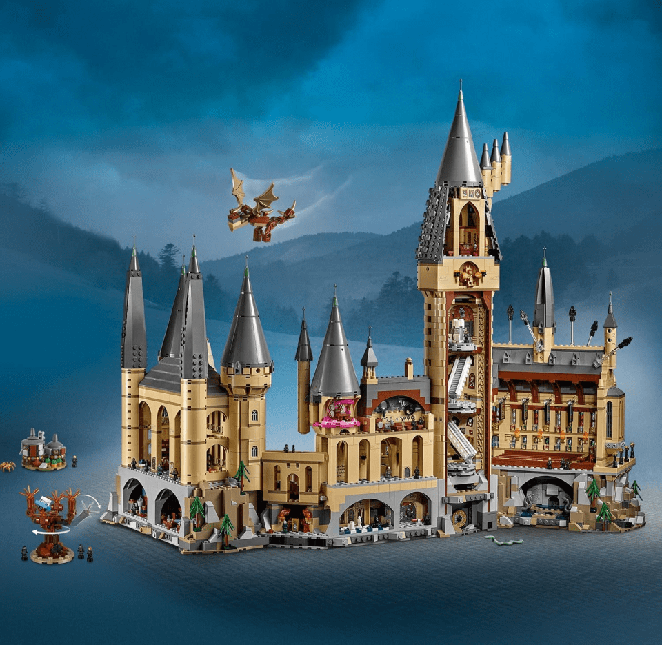 Lego model of Hogwarts Castle with a dragon flying above and the Whomping Willow.