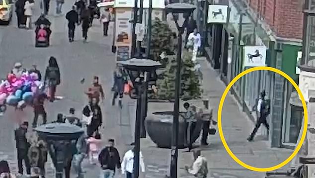 What happened next was described by a judge as 'a real-life horror film' as CCTV captured Nur suddenly pulling out a knife and thrust it into Mr Johal's chest. Pictured: Nur walking out of the bank after the attack