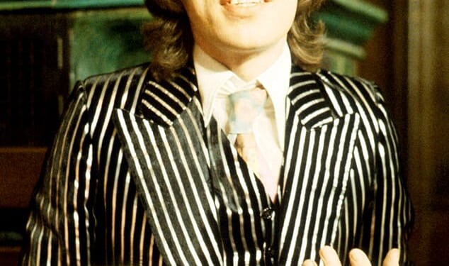Singer Mick Jagger of The Rolling Stones wearing in a Granny Takes A Trip striped suit in 1973