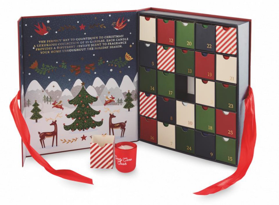 An advent calendar box for 25 candles with an illustration of Christmas trees and reindeer, and a sample "Candy Cane Crush" candle.