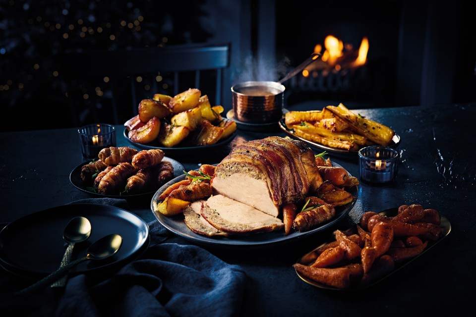 Christmas turkey with pigs in blankets, roasted potatoes, and carrots.