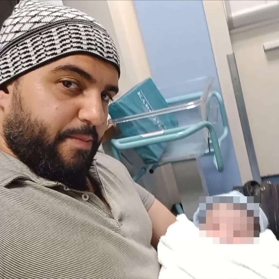 A man, identified as Faraj Al-Shamie, holding his grandson.