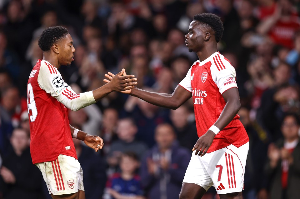 Bukayo Saka of Arsenal celebrates scoring with Myles Lewis-Skelly.