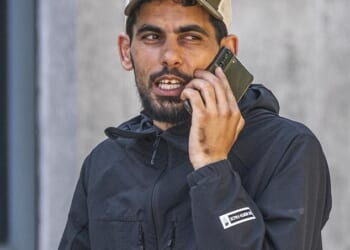 Libyan migrant Ibrahim Zouari (pictured outside court wearing a black North Face jacket), 35, has been jailed for 15 months after he brandished a chair and chased migrant hotel staff with a knife