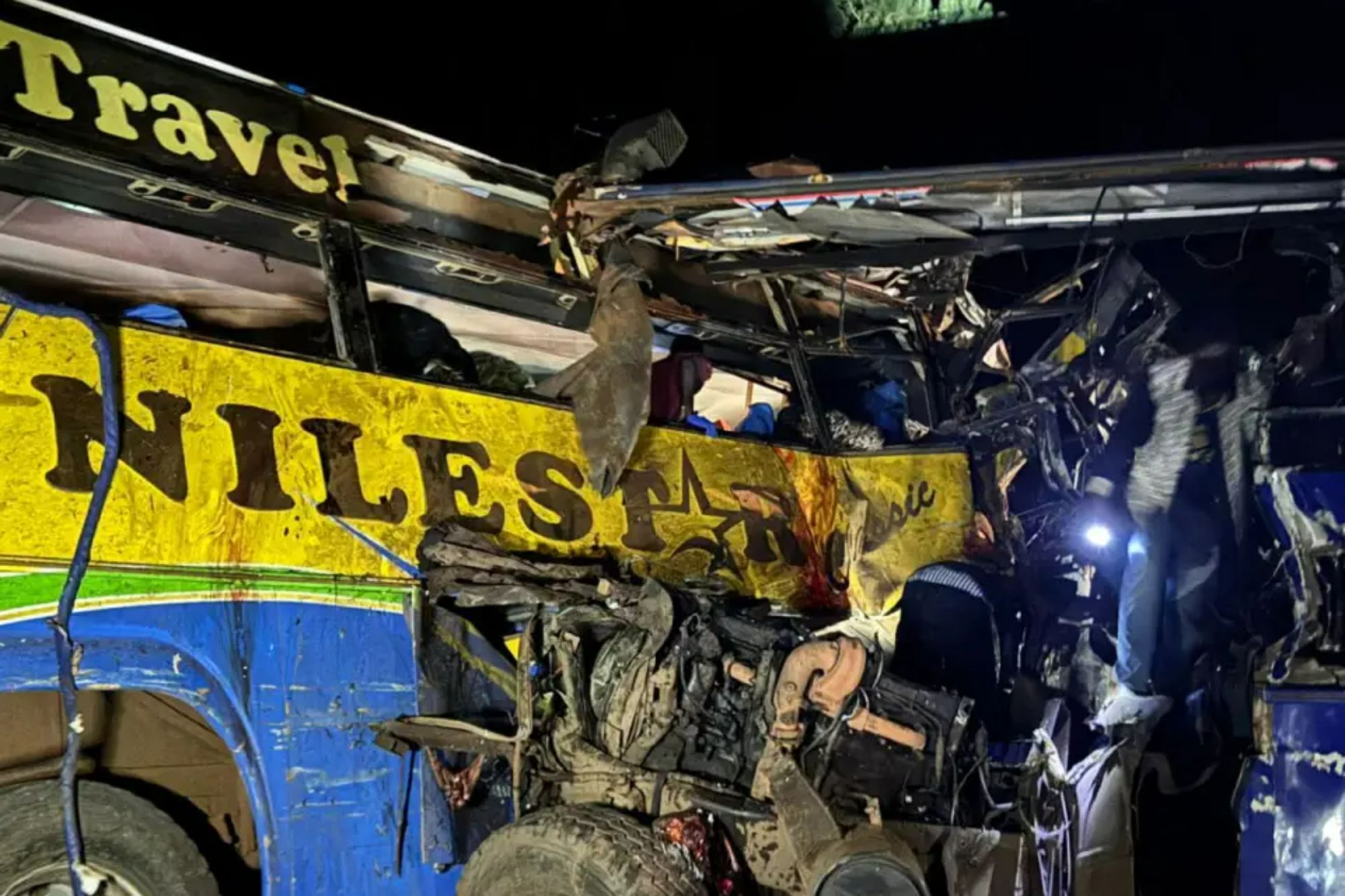 An image collage containing 1 images, Image 1 shows Wreckage of a blue and yellow bus at night