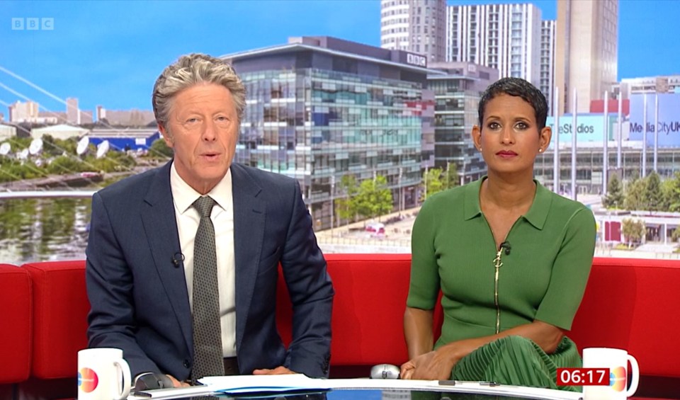 Naga Munchetty and Charlie Stayt sitting on a red couch, looking tense.