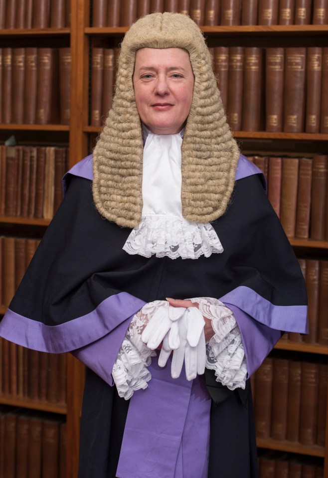 Judge Maria Jane Carmel Lamb wearing a barrister's wig, robe, and holding white gloves.