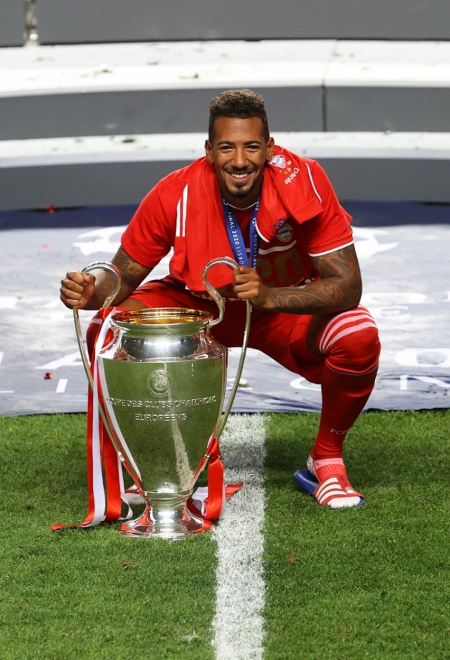 Jerome Boateng holding the UEFA Champions League trophy.