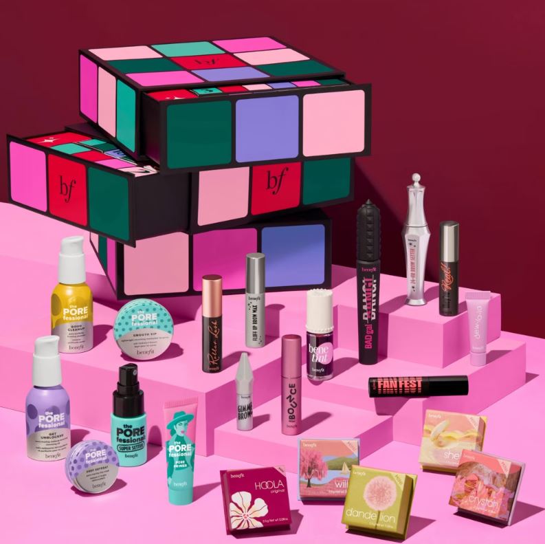 Benefit Advent Calendar with various Benefit Cosmetics products on pink risers.
